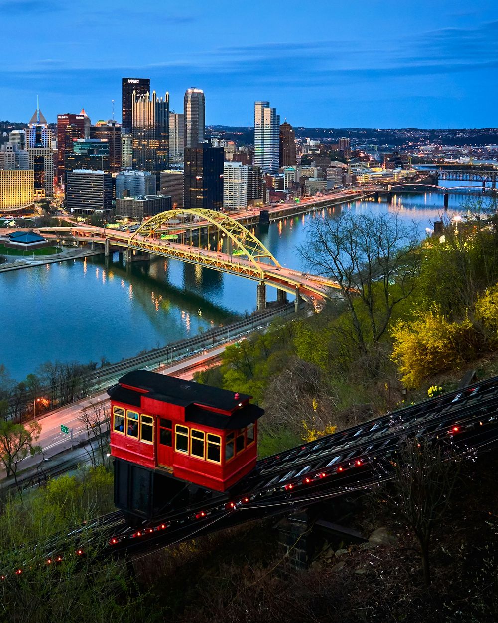 The Duquesne Incline car climbing Mount Washington above downtown Pittsburgh at dusk