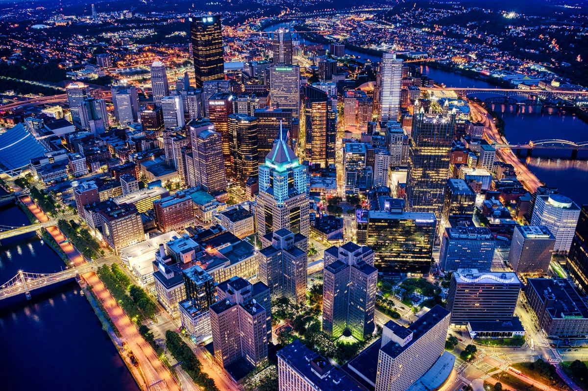Downtown Pittsburgh lit up at night from above
